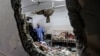 FILE - People inspect the damage in a room following Israeli bombardment at Nasser hospital in Khan Yunis in the southern Gaza Strip on Dec. 17, 2023.