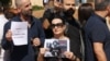 A woman holds a portrait of video journalist Issam Abdallah, killed Oct. 13 by strikes on the village of Alma al-Shaab in southern Lebanon while he and others were covering cross-border shelling, during a protest in Beirut, Lebanon, Oct. 15, 2023.
