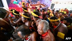 Brazilian Indigenous people celebrate after Brazil's Supreme Court ruled against efforts to restrict native peoples' rights to reservations on their ancestral lands in Brasilia on Sept. 21, 2023. 