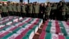 FILE - Revolutionary Guard members stand over the flag-draped coffins of victims of a bomb explosion in the city of Kerman, Iran, Jan. 5, 2024. The Islamic State claimed responsibility for the attack. On April 6, 2024, Iran media reported the arrest of three suspected IS members.