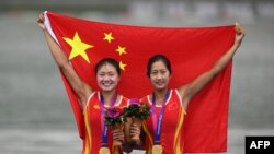 Gold medalists Lu Shiyu and Shen Shuangmei of China pose for a photo during a medal ceremony after the women's double sculls final event of rowing during the 2022 Asian Games in Hangzhou in China's eastern Zhejiang province on Sept. 24, 2023.