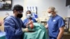 FILE — This photo released by the University of Maryland School of Medicine shows surgeons transplanting a heart from a genetically modified pig to a patient in Baltimore, Maryland, on Jan. 7, 2022. This week, the medical school performed a similar procedure on another patient.