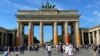 People walk in front of the Brandenburg Gate after Last Generation ("Letzte Generation") climate activists threw paint on the columns of the Brandenburg Gate in Berlin, Germany, Sept. 17, 2023. 