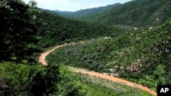 FILE - The Sonora River, contaminated by the spill of about 40 million liters of copper sulfate and heavy metals from the Buenavista copper mine, makes its way through the hills in the northern state of Sonora, Mexico, Aug. 12, 2014. 