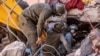 Rescue workers search for survivors in a collapsed house in Moulay Brahim, Al Haouz province, Morocco, after an earthquake, Sept. 9, 2023.