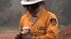 FILE - A fireman holds a wild rabbit he rescued from a bushfire burning in the southern Sydney suburb of Menai, Dec. 3, 1997.
