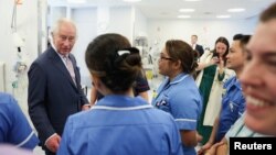 Britain's King Charles meets with staff members during a visit to the University College Hospital Macmillan Cancer Centre in London, Britain, April 30, 2024.