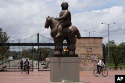 A sculpture by Colombian artist Fernando Botero, titled Man on Horseback, stands outside Renaissance Park in Bogota, Colombia, Sept. 15, 2023.