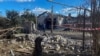 Pria lokal berdiri di samping bangunan tempat tinggal yang rusak akibat serangan rudal Rusia, di tengah serangan Rusia ke Ukraina, di desa Obukhivka, wilayah Dnipropetrovsk, Ukraina 18 Oktober 2023. (REUTERS/Mykola Synelnykov)