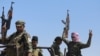 Fighters of the Syrian Democratic Forces (SDF) gesture as they move to the Dhiban front line in eastern Syria's Deir el-Zour province, Sept. 4, 2023, during a guided media tour organized by the SDF.