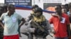 Accused Somali pirates wait to be transferred to police custody as Indian naval commandos stand guard at the dockyard in Mumbai on March 23, 2024. 