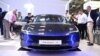 Visitors inspect a Tesla model 3 car on display at the International Motor Show (IAA) in Munich, southern Germany, Sept. 4, 2023.