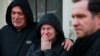 Relatives mourn during the funeral of a victim of a cyclone that hit Mucum, Rio Grande do Sul, Brazil, during his funeral in the city's cemetery, on Sept. 9, 2023. 