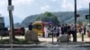 Medics and emergency personnel work at the site where a person wounded four children and an adult in a knife attack in a park in Annecy, France, June 8, 2023.