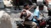 FILE - People take a man who was shot in the head during violent gang clashes to a hospital in the Carrefour-Feuilles district of Port-au-Prince, Haiti, Aug. 15, 2023.
