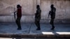 FILE - U.S.-backed Syrian Democratic Forces soldiers search for Islamic State militants in Hassakeh, Syria, Jan. 28, 2022. U.S. Central Command said Sept. 25, 2023, that its forces had captured IS leader Abu Halil al-Fad'ani during a raid. 