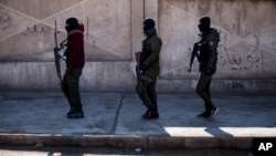 FILE - U.S.-backed Syrian Democratic Forces soldiers search for Islamic State militants in Hassakeh, Syria, Jan. 28, 2022. U.S. Central Command said Sept. 25, 2023, that its forces had captured IS leader Abu Halil al-Fad'ani during a raid. 