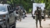 Mexican armed forces stand guard near a crime scene where several local police officers were shot dead by gunmen, in Coyuca de Benitez, Mexico, Oct. 23, 2023.