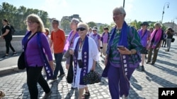 FILE - Supporters of Women's Ordination Conference, advocating and praying for the ordination of women as deacons, priests, and bishops into an inclusive and accountable Roman Catholic Church, demonstrate by the Vatican in Rome on Oct. 6, 2023.