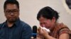 A Myanmar national reacts during a press conference after filing a criminal complaint in Manila, Philippines, Oct. 25, 2023. 