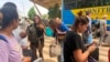 FILE - French nationals gather as they wait to be airlifted back to France on a French military aircraft, at the international airport in Niamey, Niger, Aug. 1, 2023.