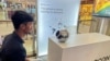 FILE - An engineer in Bengaluru, India, signs up for Worldcoin by having his eyes scanned by the spherical device at a local mall on July 25, 2023. A panel in Kenya has urged the shutdown of the crypto project there pending more stringent regulations. 