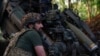 A Ukrainian serviceman prepares to fire a howitzer toward Russian troops near the front line in Donetsk region, Ukraine May 1, 2024. 