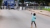 A young boy gestures at police as demonstrators gather in the streets for a third day of anti-government protests in Accra, Ghana, Sept. 23, 2023.