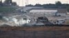 Israeli soldiers and Palestinian protesters clash near the border between Israel and the Gaza Strip as seen from the Israeli side, Sept. 23, 2023.
