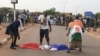 FILE - Protesters defile a French national flag during a rally in Niamey, Niger, Sept. 1, 2023, demanding the departure of French troops from Niger.