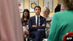 FILE - Photo taken August 17, 2023 shows French Education Minister Gabriel Attal (C) at a meeting at the Bourbon high school in Saint-Denis-de-la-Reunion on the first day of school.