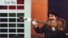 FILE - An auction house worker shows off Paul McCartney's 1964 custom Hofner 500/1 violin bass guitar during an internationally televised auction of the Beatles memorabilia collection in Tokyo, Japan, March 22, 1997.