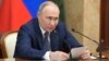 Russian President Vladimir Putin speaks during a meeting with Cabinet members in Moscow, May 6, 2024. Putin thanked Cabinet ministers for their work ahead of his inauguration on May 7, 2024. 