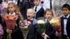 First-graders take part in a ceremony marking the start of classes at a school as part of the traditional opening of the school year known as 'Day of Knowledge' in St. Petersburg, Russia, Sept. 1, 2023. 