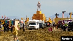 The Man structure, which is normally burned on Saturday night, looms over the Burning Man encampment after a severe rainstorm left tens of thousands of revelers stranded in mud in the Nevada desert, Sept. 3, 2023. (USA Today Network via Reuters)