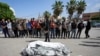 Palestinians prayer next to the bodies of their relatives who were killed in an Israeli airstrike in Gaza Strip, at the Al Aqsa hospital in Deir al Balah, Gaza, May 4, 2024. 