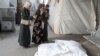 Mourners react next to the bodies of Palestinians killed in an Israeli strike, at Abu Yousef al-Najjar hospital in Rafah, May 5, 2024. 
