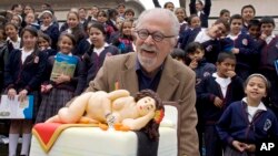 FILE — Colombian artist Fernando Botero laughs next to a cake decorated with a pastry made in the likeness of one of his sculptures during his 80th birthday celebration at the Botero Museum in Bogota, Colombia, April 19, 2012.