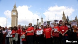 People impacted by the contaminated blood scandal gather in Westminster for a vigil to remember those that lost their lives, ahead of the release of final report of the Infected Blood Inquiry on Monday, London, May 19, 2024.