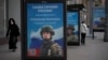FILE - A billboard shows a picture of a Russian soldier awarded with a medal for his actions in Ukraine, in Moscow, Russia, Nov. 15, 2022.