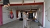 An Afghan man inspects gear at the Mellat boxing club, a day after an explosion took place at the site in Kabul, Oct. 27, 2023. 