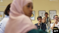 FILE - Photo taken August 17, 2023 shows French Education Minister Gabriel Attal, center, attending a meeting at the Bourbon high school on the French overseas island of La Reunion.