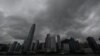 Heavy rain clouds are seen covering Central district in Hong Kong, Oct. 8, 2023, as Typhoon Koinu skirts the financial hub, bringing rains and powerful gusts