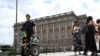 A police officer on a Segway patrols Sweden's parliament building in Stockholm, Aug. 17, 2023. (Fredrik Sandberg/TT News Agency/via Reuters)