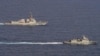 The U.S. Navy's USS Ralph Johnson guided missile destroyer (L) and the Philippine Navy frigate BRP Jose Rizal sail through waters west of Palawan in the South China Sea, Sept. 4, 2023.