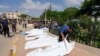 A man looks at a dead body, after a powerful storm and heavy rainfall hit Libya, in Derna, Libya Sept. 12, 2023. 