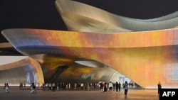 People walk outside the Chengdu Science Fiction Museum during Worldcon, the World Science Fiction Convention, in Chengdu, in China’s southwest Sichuan province, Oct. 21, 2023.