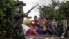 ကယားပြည်နယ် လွိုင်ကော်မြို့မှာ တိုက်ပွဲဖြစ်နေစဉ်အတွင်း ထွက်ပြေးတိမ်းရှောင်နေကြတဲ့ မြို့ခံများနှင့် ကရင်နီအမျိုးသားကာကွယ်ရေးတပ်ဖွဲ့ဝင်တဦး (KNDF) ကို တွေ့ရစဉ် (နိုဝင်ဘာ ၁၄၊ ၂၀၂၃)