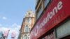 FILE - Branding is displayed for Vodafone at one of its stores in London, Britain, June 14, 2023.