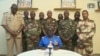This video frame grab image obtained by AFP from ORTN - Télé Sahel on July 26, 2023, shows Colonel Major Amadou Abdramane, center, spokesperson for the National Committee for the Salvation of the People, speaking during a televised statement in Niger.